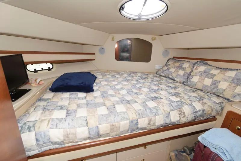 Slide: The Image of 1999 Cruisers Yachts 3750 Motoryacht cabin with bed, porthole, and cozy interior. - 25