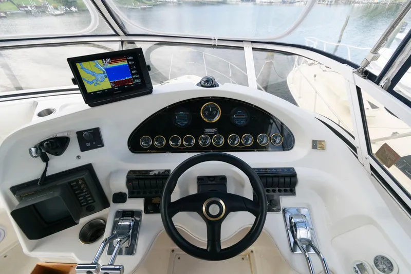Slide: The Image of 1999 Cruisers Yachts 3750 Motoryacht helm with navigation equipment and steering wheel. - 7