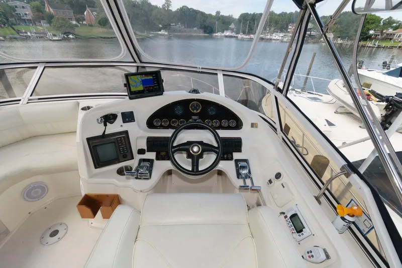 Slide: The Image of 1999 Cruisers Yachts 3750 Motoryacht helm with navigation equipment and scenic waterway view. - 8