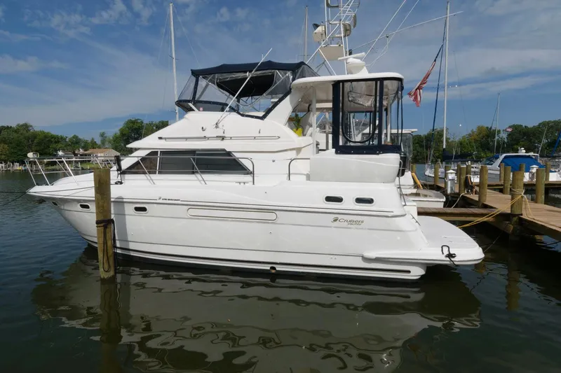 The Image of 1999 Cruisers Yachts 3750 Motoryacht docked in a marina under a clear sky. - 0