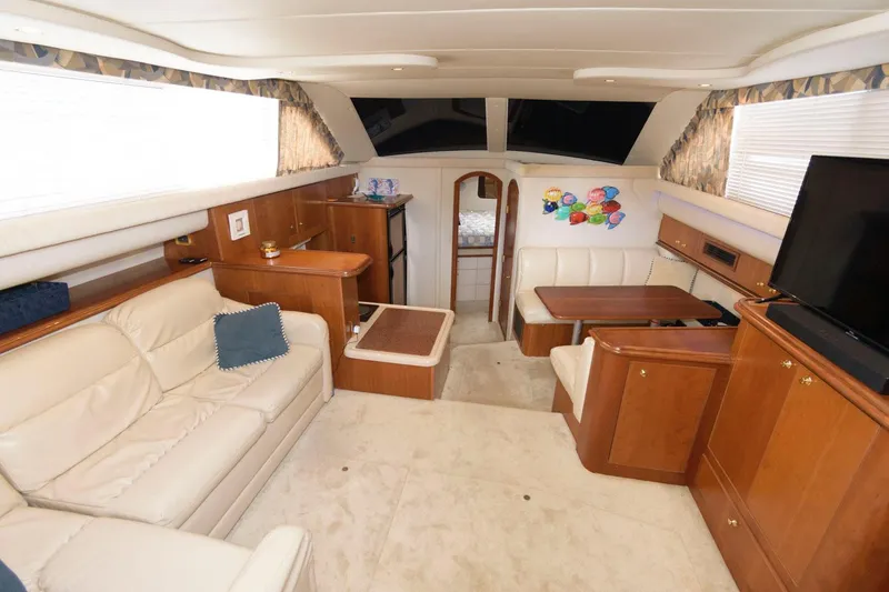 Slide: The Image of 1999 Cruisers Yachts 3750 Motoryacht interior with plush seating and elegant wood finishes. - 17