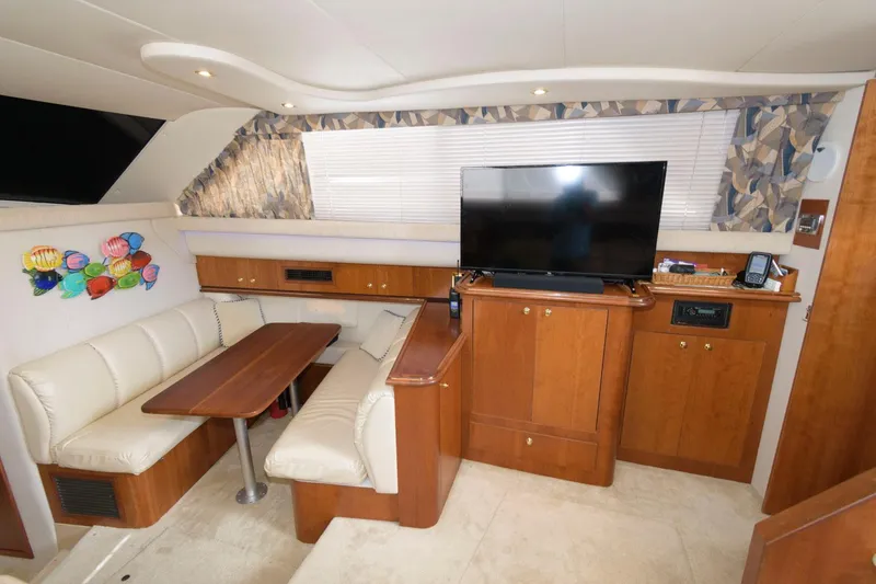 Slide: The Image of 1999 Cruisers Yachts 3750 Motoryacht interior with dining area and TV. - 20