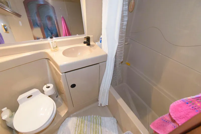 Slide: The Image of Bathroom interior of 1999 Cruisers Yachts 3750 Motoryacht with sink, toilet, and shower. - 24