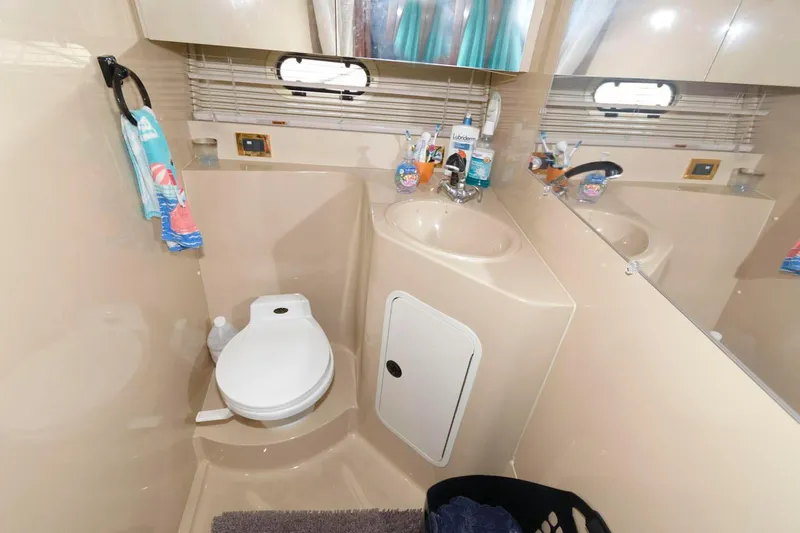 Slide: The Image of 1999 Cruisers Yachts 3750 Motoryacht bathroom with toilet, sink, and toiletries. - 26