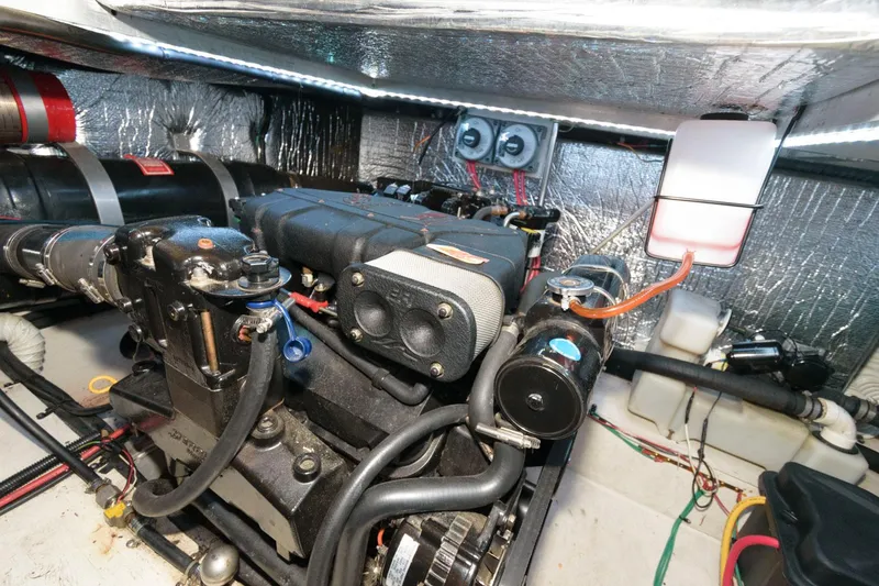Slide: The Image of Engine room of 1999 Cruisers Yachts 3750 Motoryacht, showcasing mechanical components and wiring. - 28