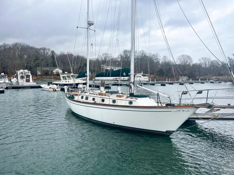 The Image of Sailboat Shannon 38, 1983 model, docked in a serene marina setting. - 0