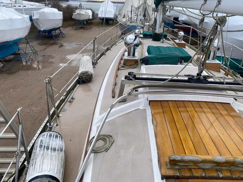 Slide: The Image of 1983 Shannon 38 sailboat on dry dock, showcasing deck and rigging details. - 18