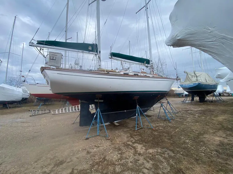 Slide: The Image of 1983 Shannon 38 sailboat on stands in a boatyard, ready for maintenance. - 21