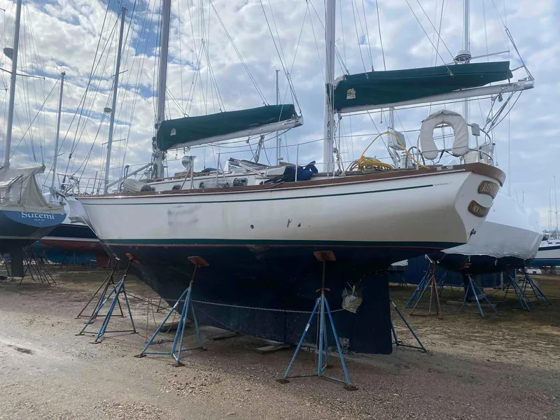Slide: The Image of 1983 Shannon 38 sailboat on stands, ready for maintenance in a boatyard. - 3