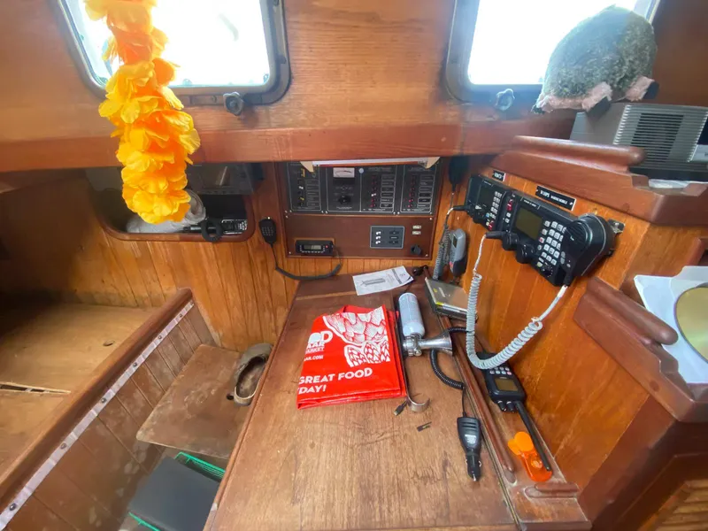Slide: The Image of 1983 Shannon 38 boat interior with navigation equipment and vibrant decor. - 9