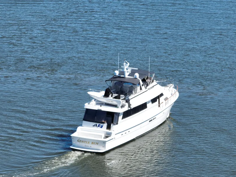 Slide: The Image of 1989 Hatteras 80 Cockpit Motor Yacht cruising on open water. - 117