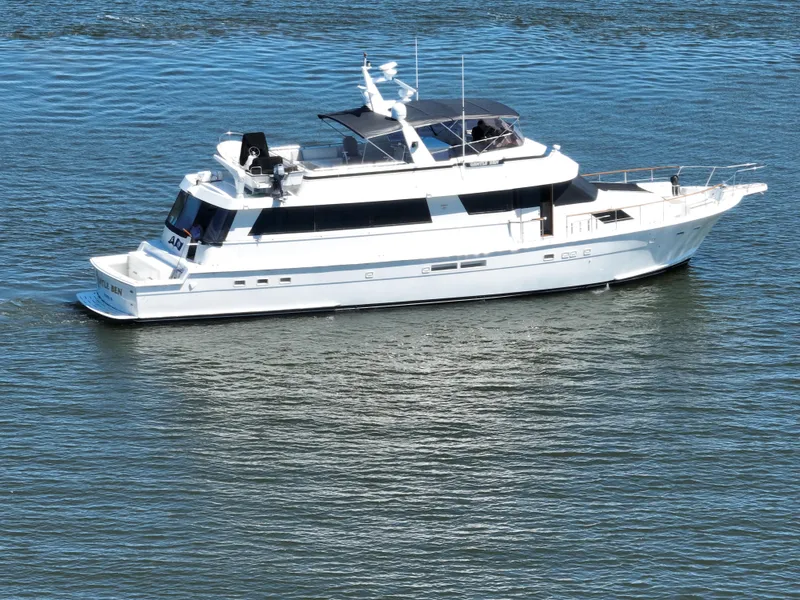 Slide: The Image of 1989 Hatteras 80 Cockpit Motor Yacht cruising on calm waters. - 118