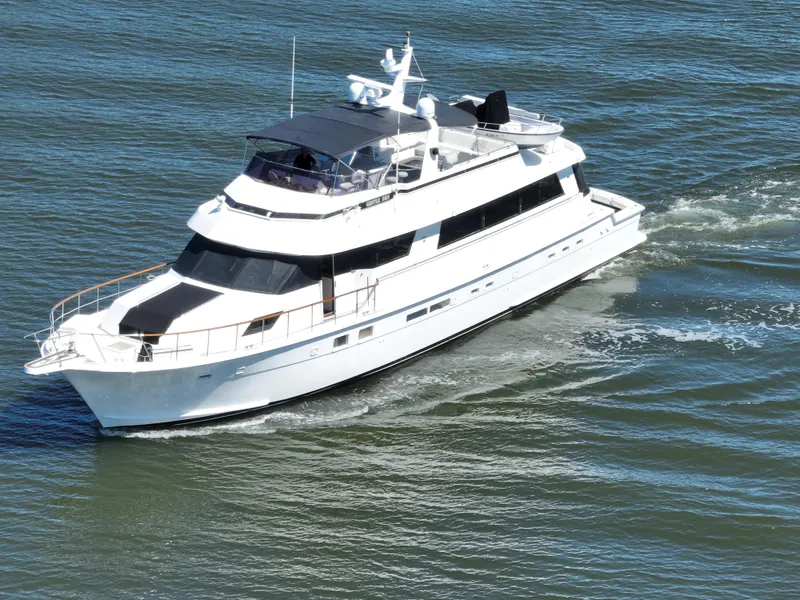 Slide: The Image of 1989 Hatteras 80 Cockpit Motor Yacht cruising on open water. - 3