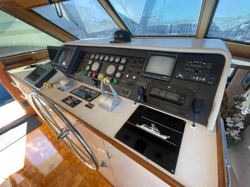 Slide: The Image of Cockpit of 1989 Hatteras 80 Cockpit Motor Yacht with navigation instruments and steering wheel. - 36