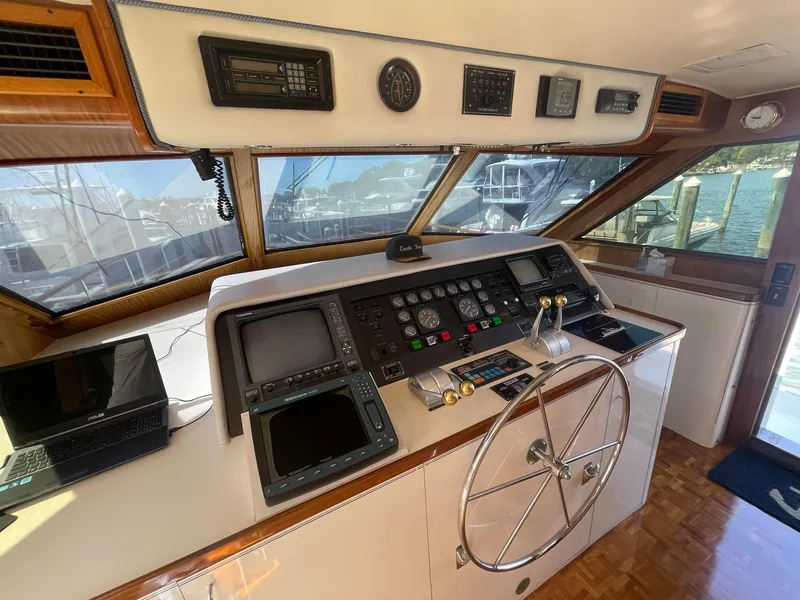 Slide: The Image of Helm of 1989 Hatteras 80 Cockpit Motor Yacht with navigation equipment and steering wheel. - 37