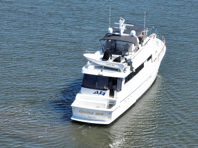 Slide: The Image of 1989 Hatteras 80 Cockpit Motor Yacht cruising on calm waters. - 4