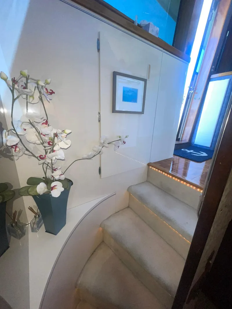 Slide: The Image of Interior staircase of 1989 Hatteras 80 Cockpit Motor Yacht with elegant decor and lighting. - 42