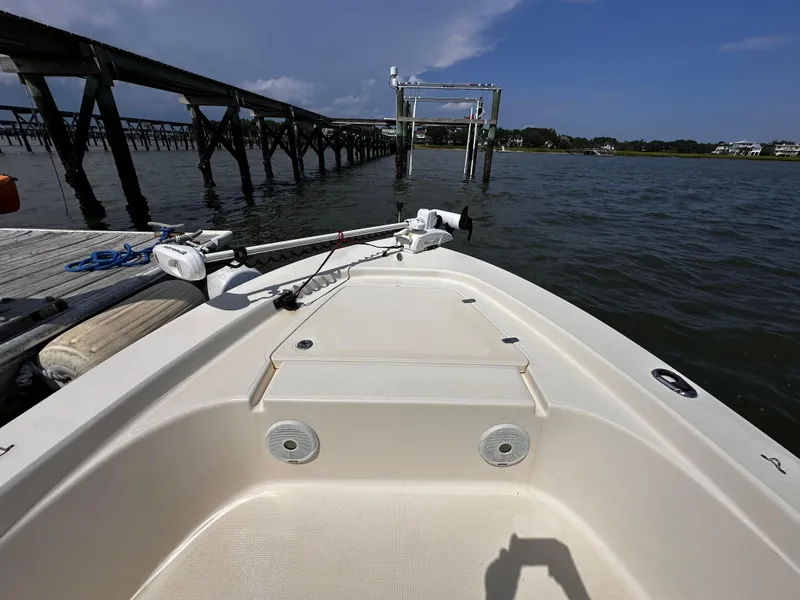 Slide: The Image of 2020 Scout 177 Sport boat docked by a wooden pier on a sunny day. - 11