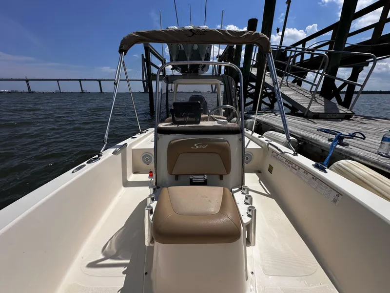 Slide: The Image of 2020 Scout 177 Sport boat docked by a pier on a sunny day. - 12