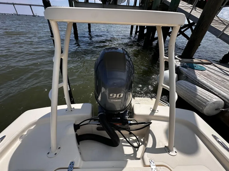 Slide: The Image of 2020 Scout 177 Sport boat with Yamaha 90 engine, docked by wooden pier. - 14