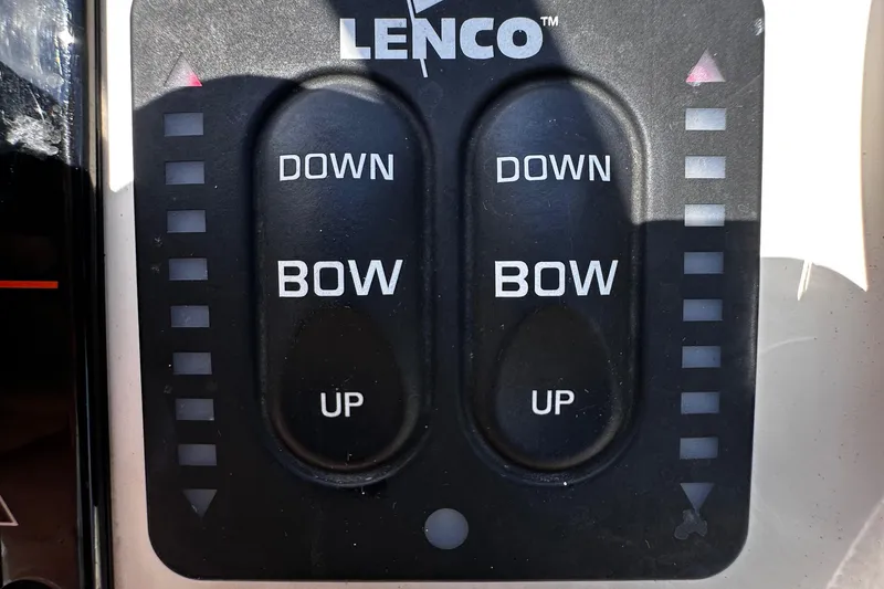 Slide: The Image of Lenco trim tab controls on a 2020 Scout 177 Sport boat dashboard. - 20