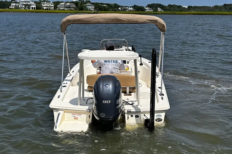 Slide: The Image of 2020 Scout 177 Sport boat on water, rear view with outboard motor and canopy. - 4