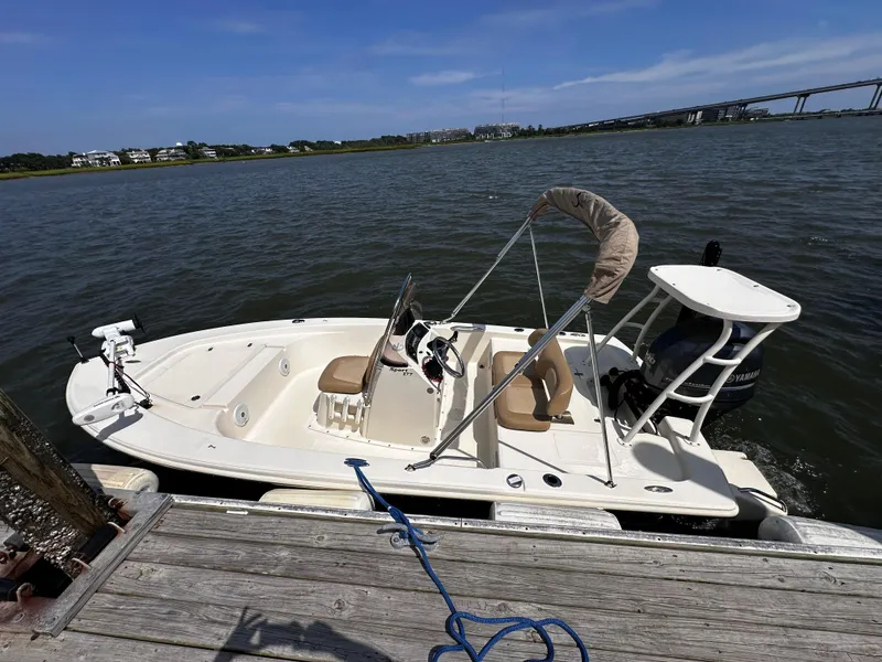 Slide: The Image of 2020 Scout 177 Sport boat docked by the water on a sunny day. - 5
