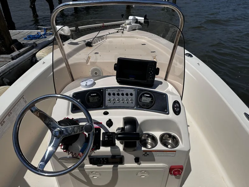 Slide: The Image of 2020 Scout 177 Sport boat dashboard with steering wheel and navigation equipment. - 9