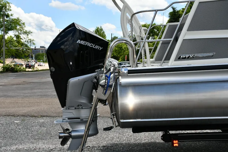 Slide: The Image of 2024 Premier 250 Solaris pontoon boat with Mercury outboard motor, parked outdoors. - 14