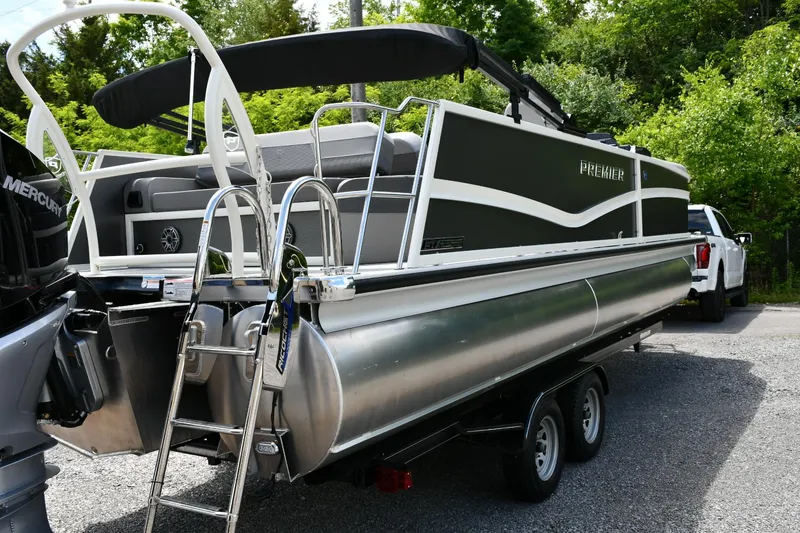 Slide: The Image of 2024 Premier 250 Solaris pontoon boat on trailer, featuring sleek design and modern amenities. - 3