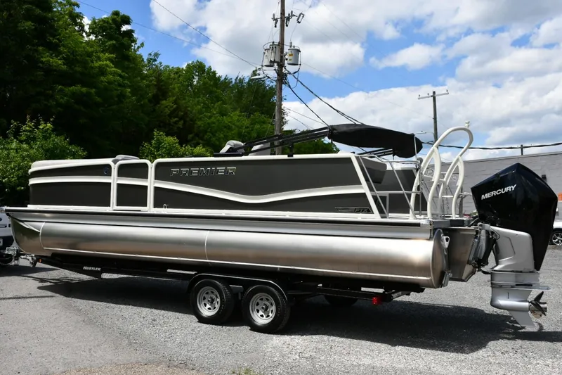 Slide: The Image of 2024 Premier 250 Solaris pontoon boat on trailer, featuring Mercury outboard motor. - 4