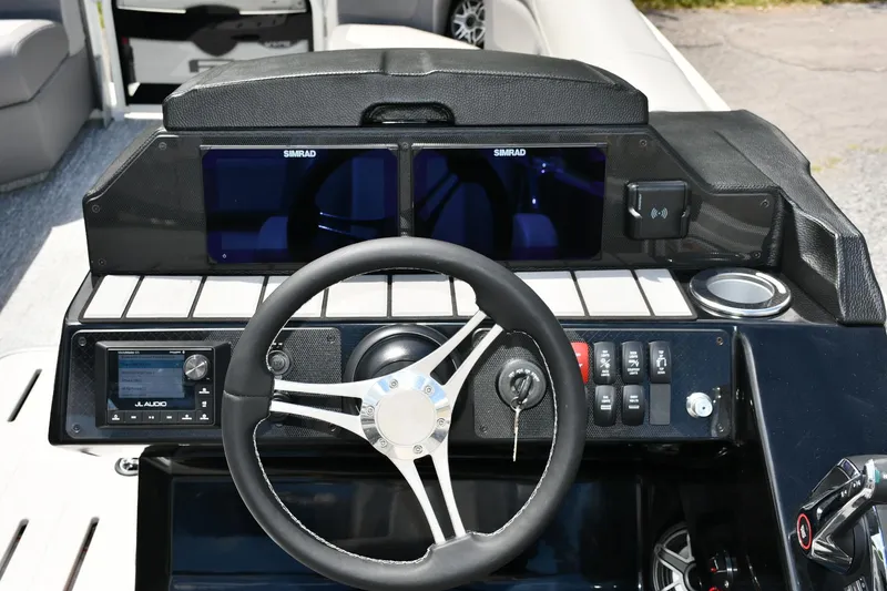 Slide: The Image of 2024 Premier 250 Solaris boat dashboard with steering wheel and dual Simrad displays. - 7