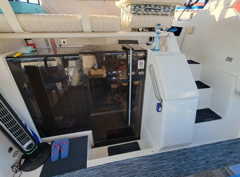 Slide: The Image of 1992 Carver 33 Aft Cabin interior with stairs, seating, and nautical decor. - 3