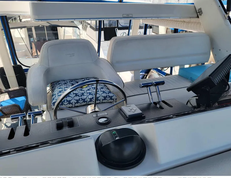 Slide: The Image of 1992 Carver 33 Aft Cabin helm with steering wheel, controls, and cushioned seating. - 2