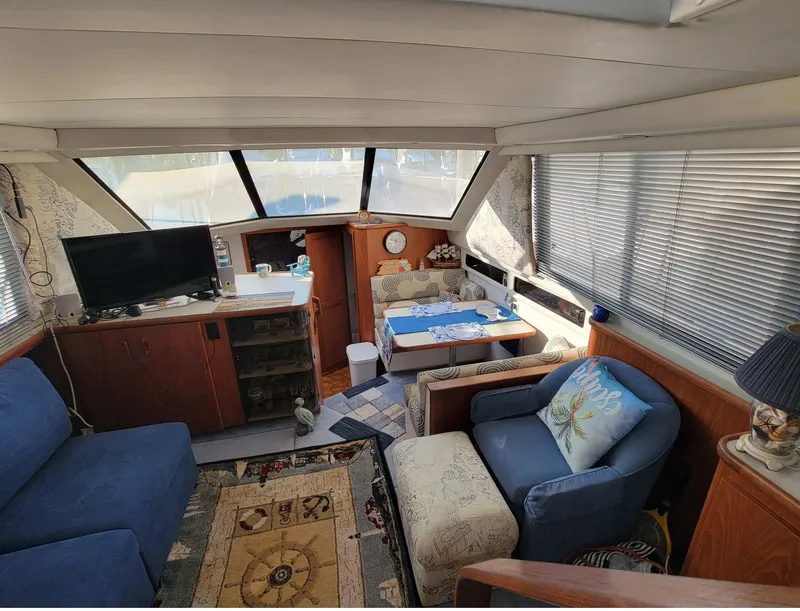 Slide: The Image of Interior of 1992 Carver 33 Aft Cabin with cozy seating and dining area. - 4