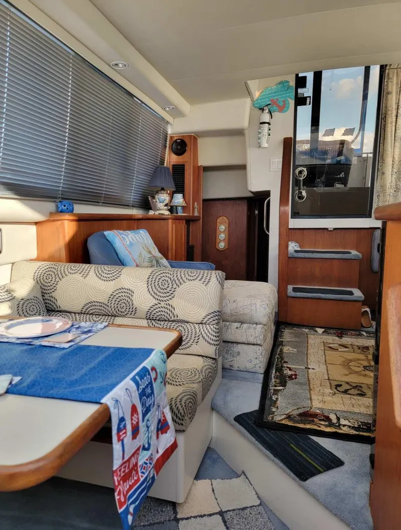 Slide: The Image of Interior of a 1992 Carver 33 Aft Cabin with cozy seating and nautical decor. - 6