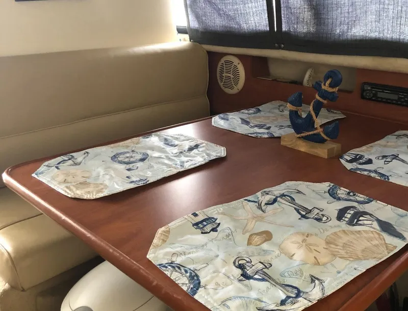 Slide: The Image of Interior of 2005 Bayliner 289 Classic with nautical-themed table setting. - 5