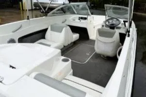 Slide: The Image of 2012 Bayliner 175 Bowrider interior with seating and steering wheel, showcasing spacious design. - 2