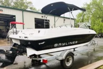 Slide: The Image of 2012 Bayliner 175 Bowrider on trailer, parked outside a garage. - 3