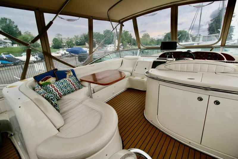 Slide: The Image of 2001 Maxum 4600 SCB yacht interior with plush seating and wooden accents. - 10