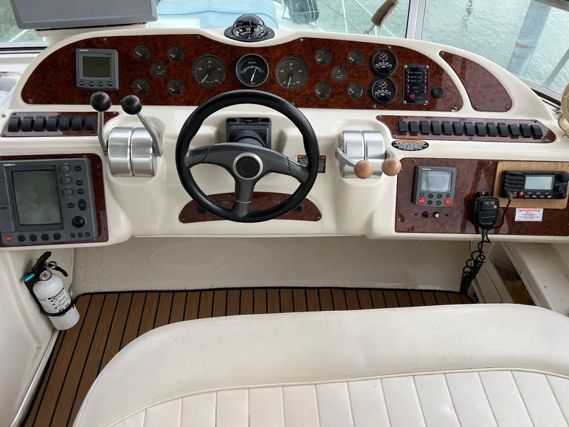 Slide: The Image of 2001 Maxum 4600 SCB yacht helm with steering wheel, controls, and navigation instruments. - 11