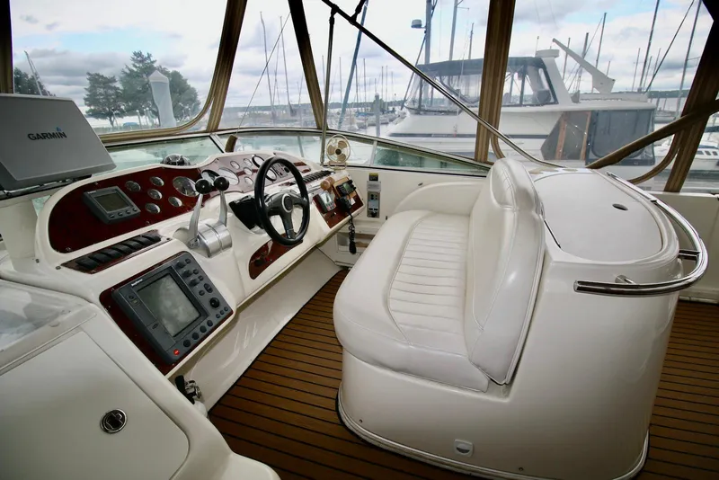 Slide: The Image of 2001 Maxum 4600 SCB yacht helm with modern navigation equipment and plush seating. - 12