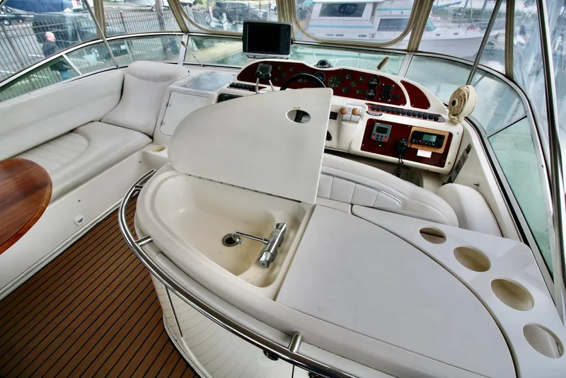 Slide: The Image of Luxurious interior of a 2001 Maxum 4600 SCB yacht with helm and seating area. - 13