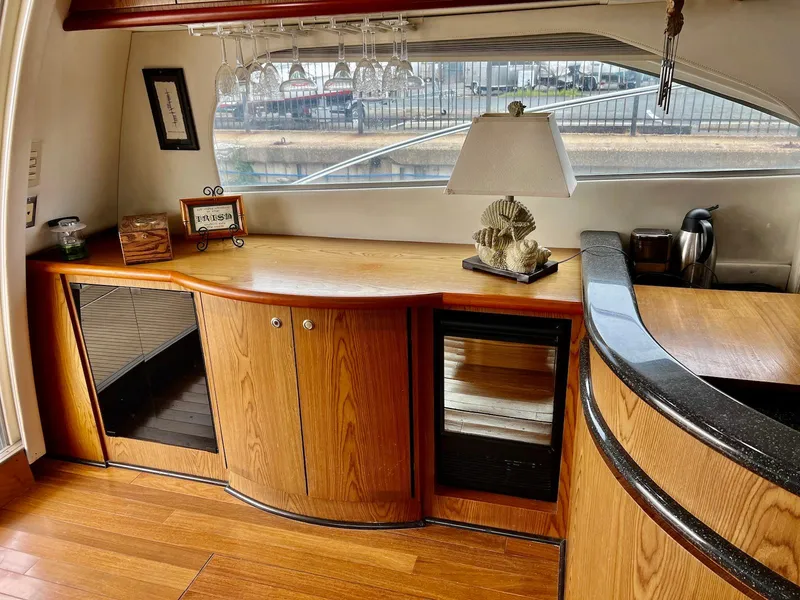 Slide: The Image of 2001 Maxum 4600 SCB yacht interior with wooden cabinetry, countertop, and decorative lamp. - 18