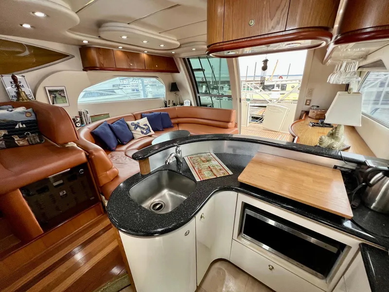 Slide: The Image of Luxurious interior of 2001 Maxum 4600 SCB yacht with modern kitchen and seating area. - 21