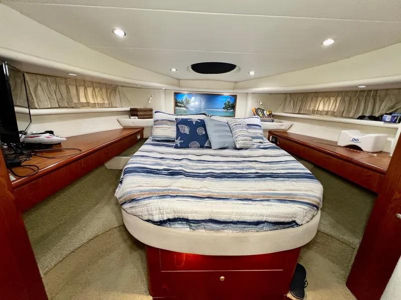 Slide: The Image of Luxurious bedroom interior of 2001 Maxum 4600 SCB yacht with cozy bedding and elegant wood finish. - 24