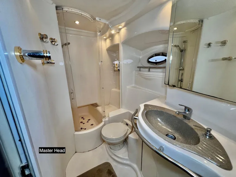 Slide: The Image of Luxurious bathroom in 2001 Maxum 4600 SCB yacht, featuring shower and elegant sink. - 29