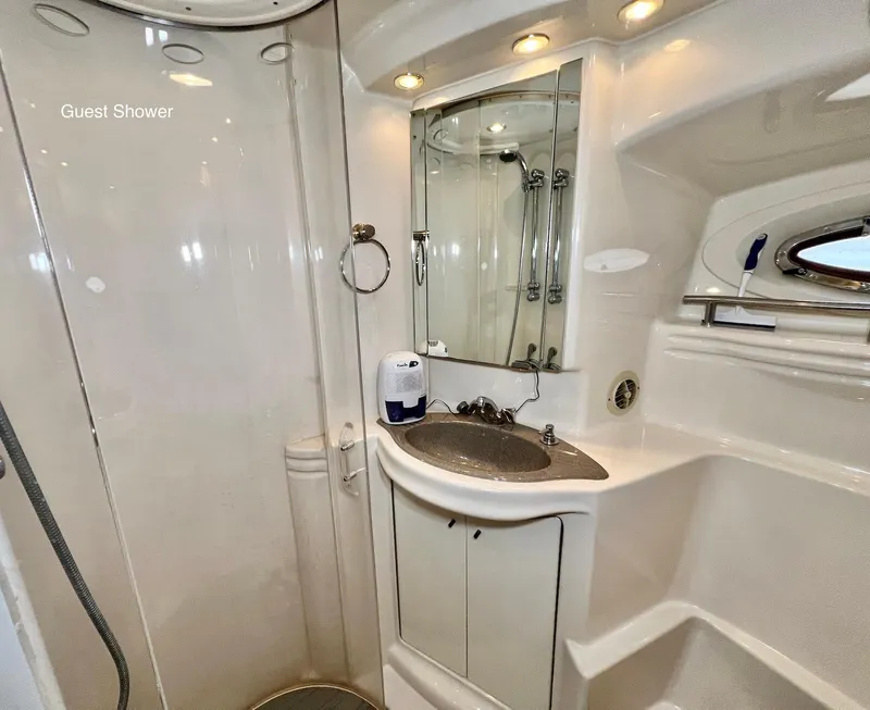 Slide: The Image of 2001 Maxum 4600 SCB guest shower with sink, mirror, and storage cabinets. - 33