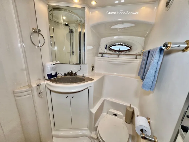 Slide: The Image of 2001 Maxum 4600 SCB yacht bathroom with sink, mirror, toilet, and shower. - 34