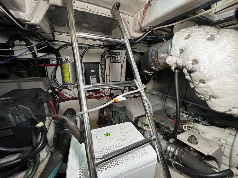 Slide: The Image of Engine room of 2001 Maxum 4600 SCB yacht, featuring ladder and mechanical components. - 35